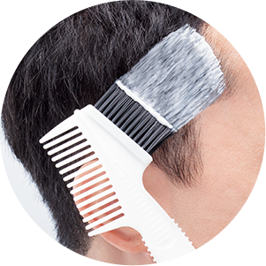 Applying hair color with brush applicator